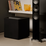 KEF Kube 15 MIE subwoofer setup in a modern home theater living room